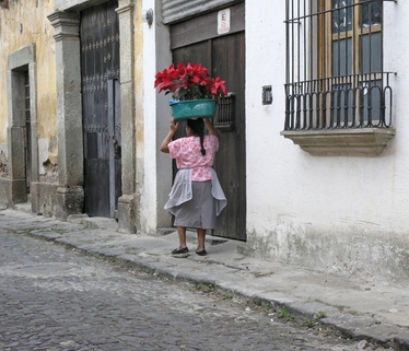 Guatemala-cult 1 streets lady carrrying flowers
