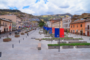 Street, old town of Quito, Ecuador, with city flag